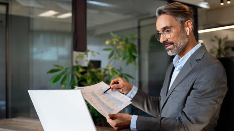 Businessman reviewing financial documents at the workplace.